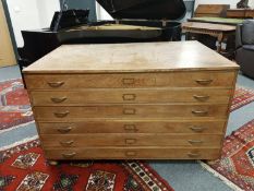 An early 20th century oak six drawer plan chest,