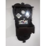 An antique hall mirror fitted with a glove box