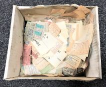 A box containing vintage bus and train tickets and labels