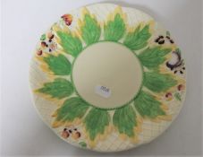 A Clarice Cliff Newport pottery plate with leaf and fruit design