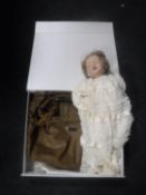A boxed Laroque hand bag and a porcelain headed doll