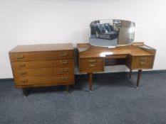 A mid twentieth century teak G-plan knee hole dressing table with matching four drawer chest