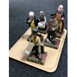 Five Aynsley porcelain Dickens characters on books including Bill Sykes, Mr.