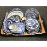 A box containing antique and later blue and white willow pattern tea and dinner plates,