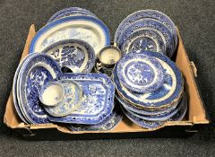 A box containing antique and later blue and white willow pattern tea and dinner plates,