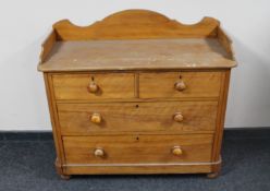 A Victorian satinwood four drawer chest on bun feet