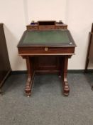 A Victorian mahogany Davenport, width 61 cm, with glass inkwells.