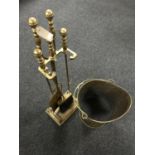 An early 20th century four piece brass companion set on stand together with a brass coal bucket