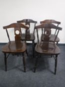 A set of four stained beech chairs