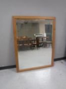 A large pine framed bevelled mirror