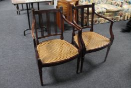 A pair of continental stained beech bergere seated armchairs