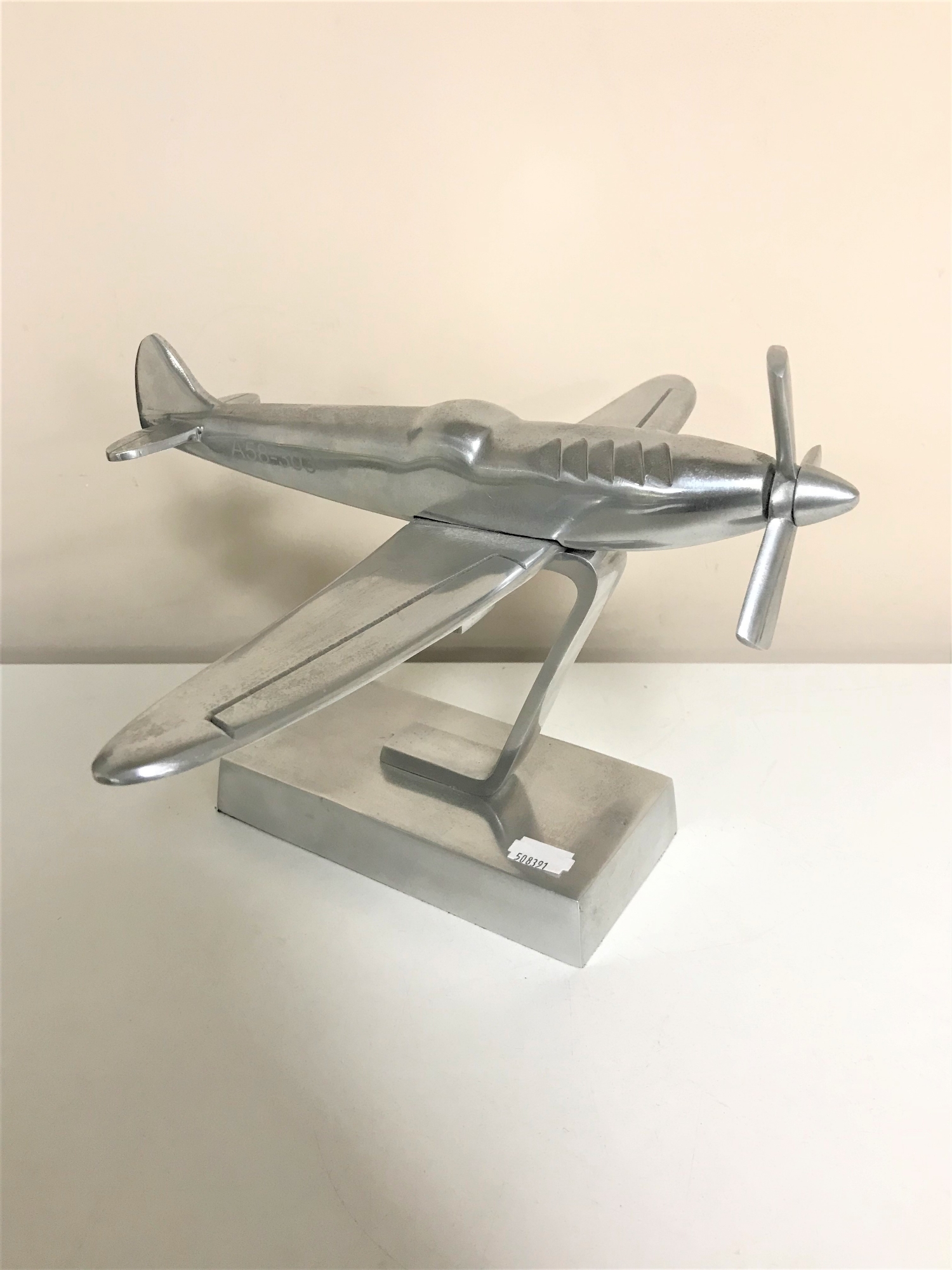A metal model of a spitfire marked A58-303