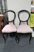 A pair of antique continental mahogany balloon backed chairs