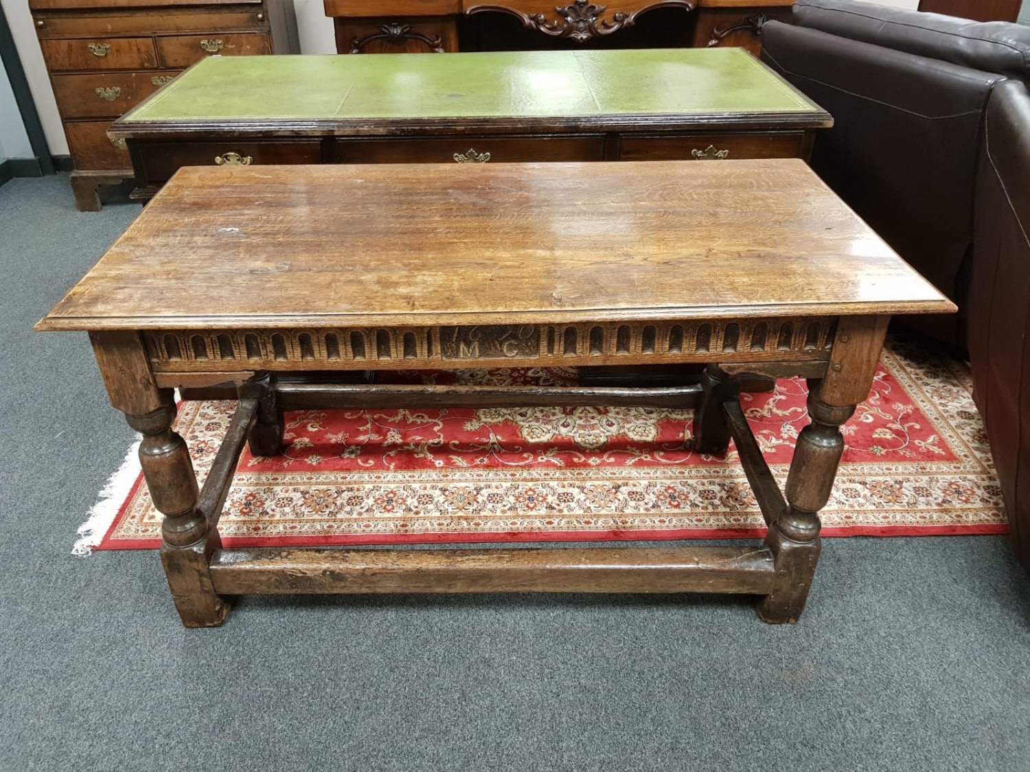 An antique carved oak table bearing date 1670,