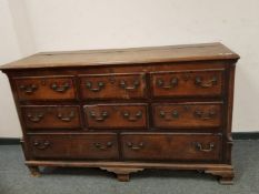 A George III oak dresser with lift up top fitted with drawers beneath, width 163 cm.