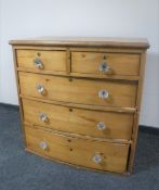 A Victorian pine bow-fronted five drawer chest with glass handles