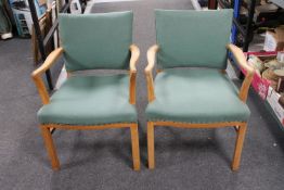 A pair of mid twentieth century blond oak armchairs upholstered in a green fabric