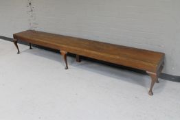 A large mahogany bench on Queen Anne style legs