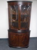 A Regency style inlaid mahogany double door corner display cabinet together with matching single