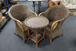 A pair of bamboo and wicker conservatory armchairs together with matching circular side table