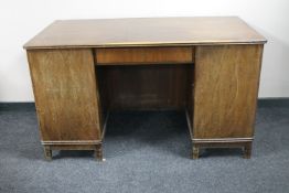 A mid twentieth century continental walnut twin pedestal writing desk