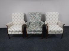 Three 20th century teak framed armchairs