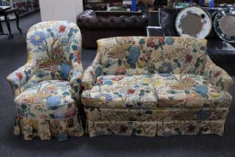 A mid twentieth century armchair and settee upholstered in floral fabric