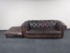 A pair of brown buttoned leather Chesterfield style settees with a square oversized footstool