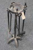 An antique three piece cast iron companion set on stand together with a coal shovel