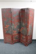 An antique Chinese red lacquered four fold room divider with double sided decoration