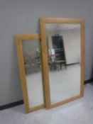 Two contemporary oak framed bevelled mirrors