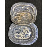 Four antique blue and white willow pattern meat plates