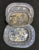 Four antique blue and white willow pattern meat plates