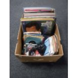 A box containing vinyl LP's and 7" singles,