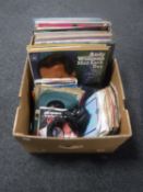 A box containing vinyl LP's and 7" singles,