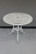 A circular painted cast metal patio table