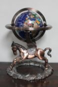 An impressive multi gemstone globe on ornate winged Pegasus base,