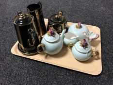 A tray containing a four piece black and gilt Victorian pottery tea service,