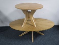 A contemporary oval coffee table with matching lamp table