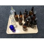 A tray of fourteen antique glass chemist's bottles