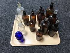 A tray of fourteen antique glass chemist's bottles