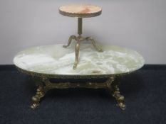 An oval onyx coffee table on ornate brass base together with a circular onyx wine table on brass