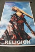 A 'Religion' shop advertising banner in tube