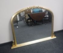 A gilt framed Victorian style arched overmantel mirror,