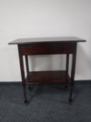 A 20th century two tier side table fitted a drawer