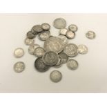 A bag of British silver coins - one shilling pieces, threepenny pieces,