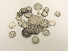 A bag of British silver coins - one shilling pieces, threepenny pieces,
