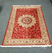 A Keshan carpet on red ground 230 cm x 150 cm