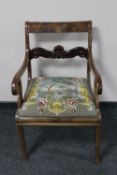 An antique continental mahogany scroll armchair with tapestry seat