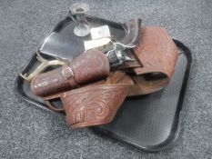 A tray of reproduction revolver in leather holster together with a pewter candlestick,